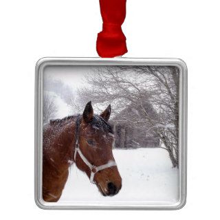 A horse near an old barn in a snow storm christmas ornaments