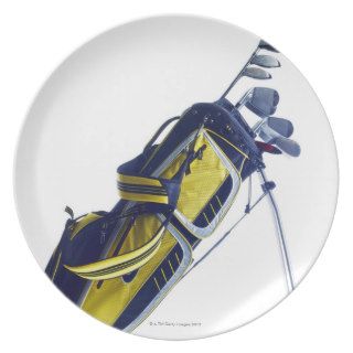Golf bag with clubs on white background dinner plate