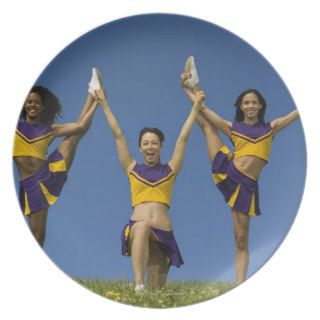 Three female cheerleaders doing formation dinner plates
