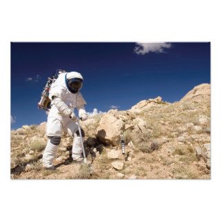 Astronaut stands beside a core sampling tool art photo