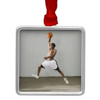 shirtless man jumping with a basketball christmas tree ornament