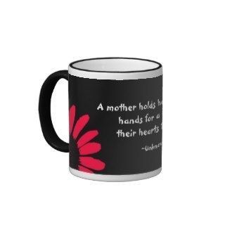 "A mother holds her" Coffee Mug