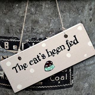 wooden sign 'the cat's been fed' by angelic hen