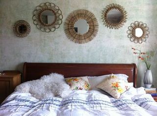 set of five rattan sunburst mirrors by the forest & co