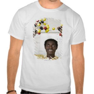 African teenage boy viewing molecule model tshirts