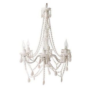 white ornate chandelier by the contemporary home