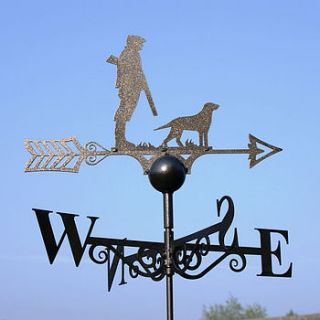 man and dog weathervane by the orchard