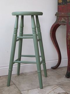 wooden painted bar stool by legs on
