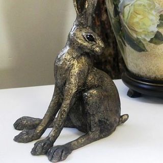 hare alert sculpture by candle and blue