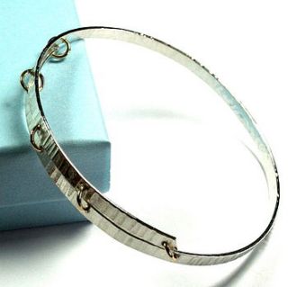 hammered bangle with gold stitches by angie young designs