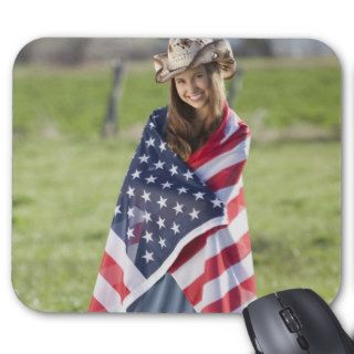 Beautiful cowgirl wrapped in American flag Mousepads
