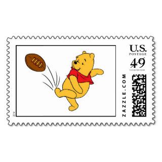 Winnie the Pooh kicks a football Stamps