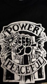 Spearhead with Michael Franti   Girls Shirt   Power to the Peaceful (Fist Holding Daisies, White on Black). On Upper Rear of Shirt is "MICHAEL FRANTI & SPEARHEAD" right below neck. Size Small. Clothing