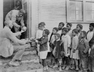 1930 photo Teacher distributing grapefruits to children outside church. Typic f1  