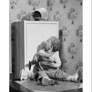 Baby boy sitting and looking at a fallen jar of cookies Poster Print (18 x 24)